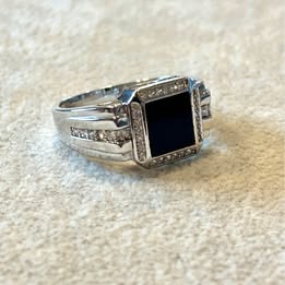 Silver tone ring with black square stone and clear accents
