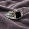 Silver tone ring with black square stone and clear accents