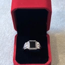 Silver tone ring with black square stone and clear accents