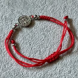 PULSERA AJUSTABLE HILO ROJO CON DIJE DE SAN BENITO, BAÑO DE RODIO, PLATA .925
