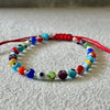 PULSERA AJUSTABLE HILO ROJO CON MULTIOJOS DE COLORES, PLATA .925