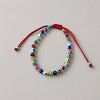 PULSERA AJUSTABLE HILO ROJO CON MULTIOJOS DE COLORES, PLATA .925