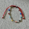 PULSERA AJUSTABLE HILO ROJO BOLITAS LISAS CON OJITO MULTICOLOR, PLATA .925