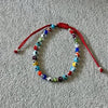 PULSERA AJUSTABLE HILO ROJO CON MULTIOJOS DE COLORES, PLATA .925
