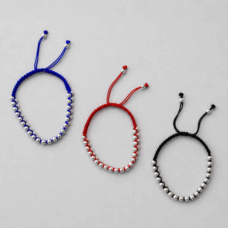 Pulso trensado con bolitas de plata color rojo, azul, o negro